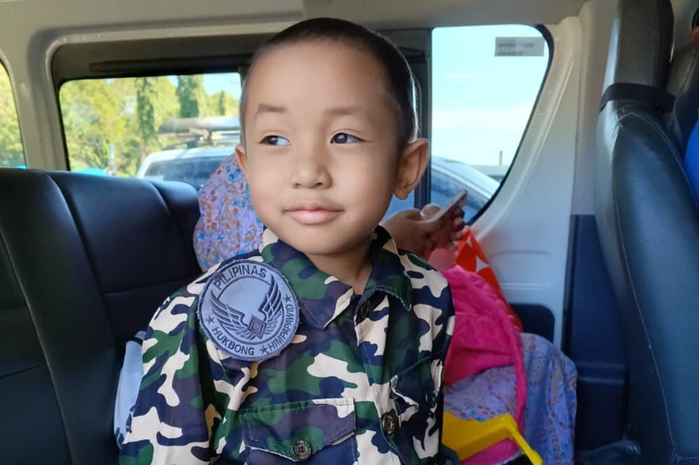 Marius Niklaus sits in a vehicle wearing a Philippine military costume.